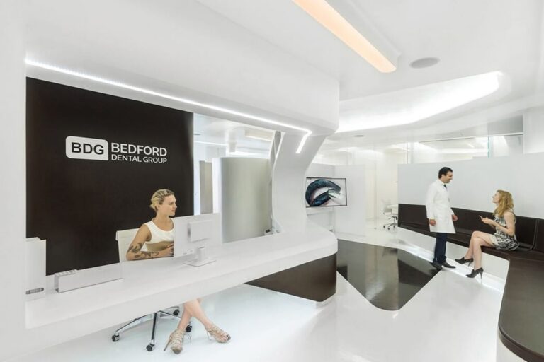 Reception at Bedford Dental Group, Beverly Hills, with the branded wall behind the desk