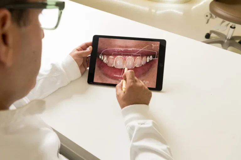 Dr. Daniel Naysan reviewing a digital smile design on an iPad at Bedford Dental Group, Beverly Hills